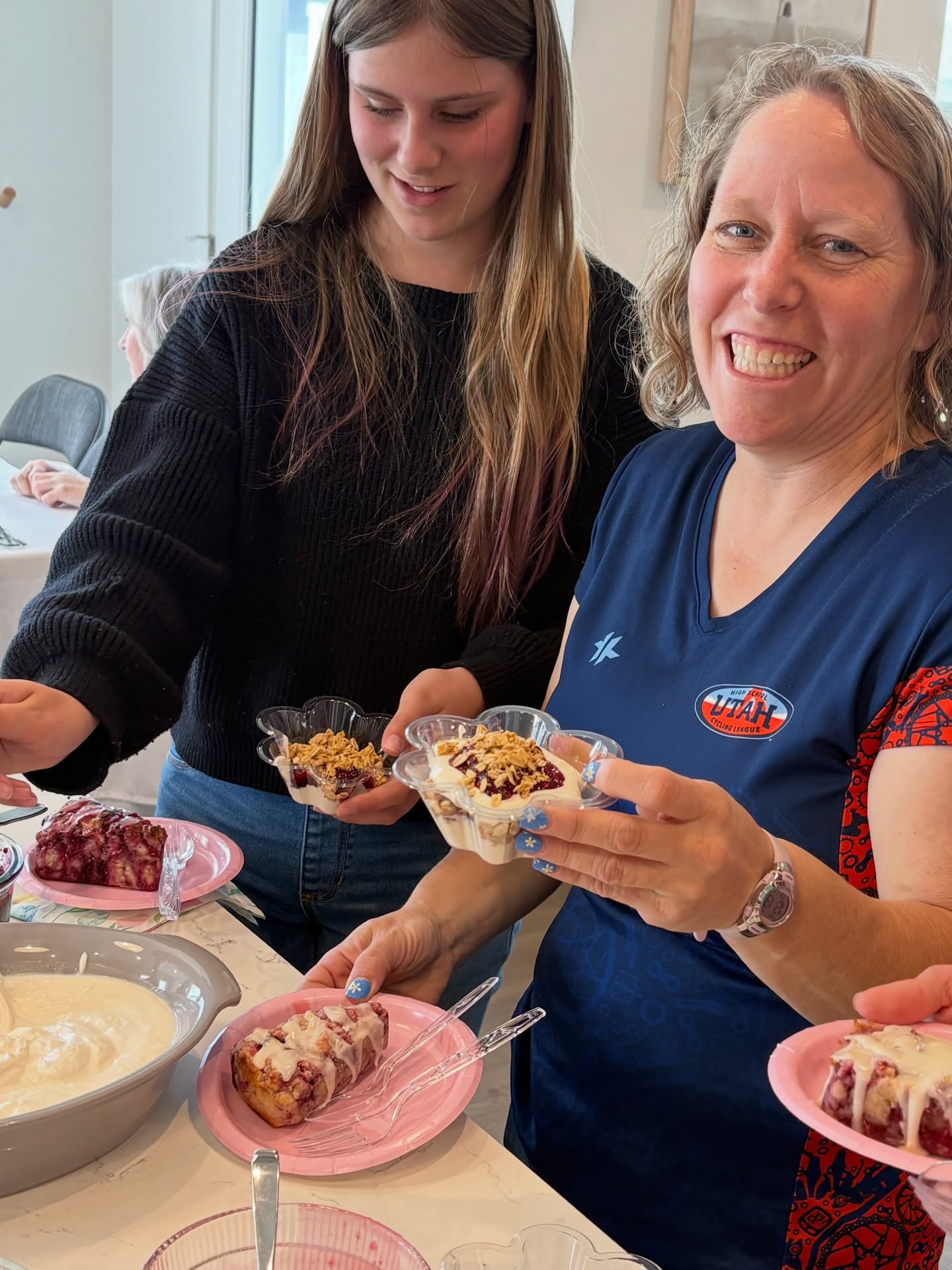 Guests laughing while holding yogurt parfaits at an event