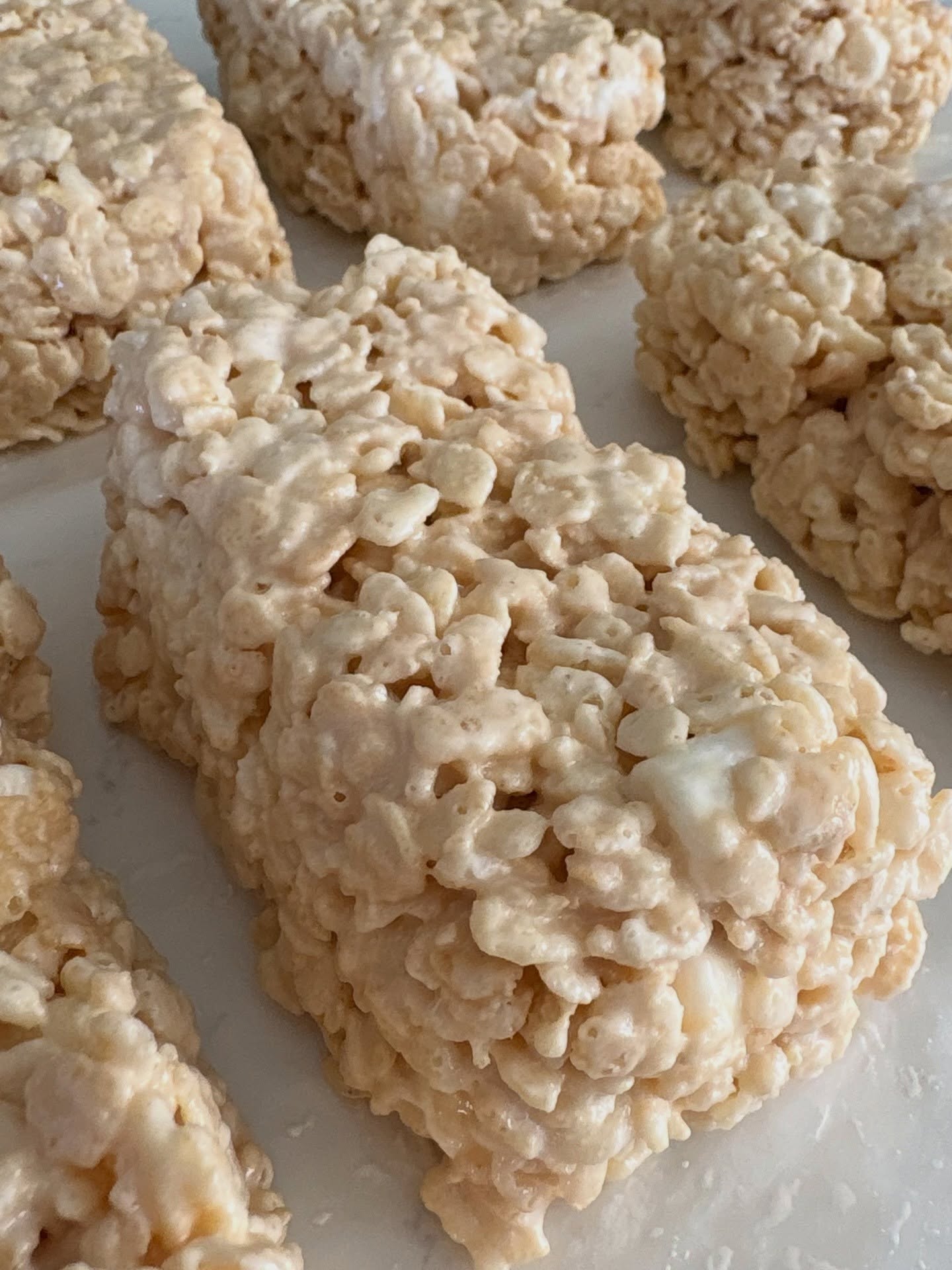 Thick, gooey caramel rice krispie treats with melty marshmallow