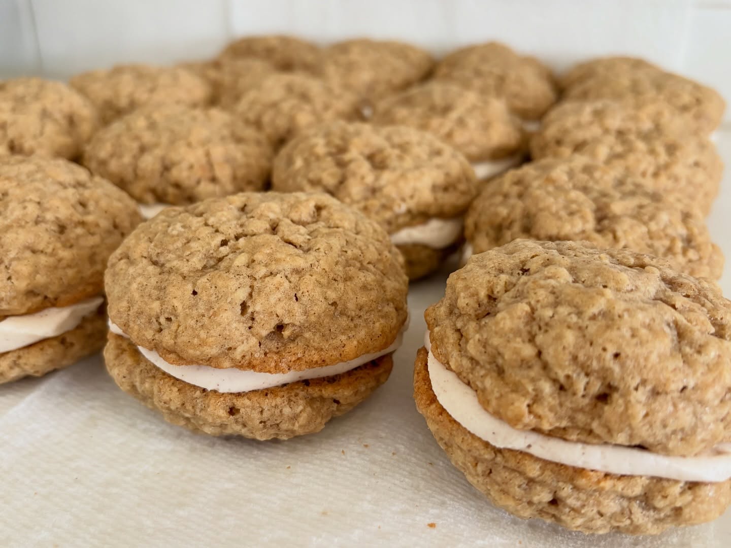 A tray of soft oatmeal whoopie pies filled with cream